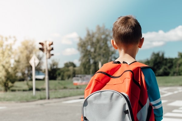 Child with backpack walking