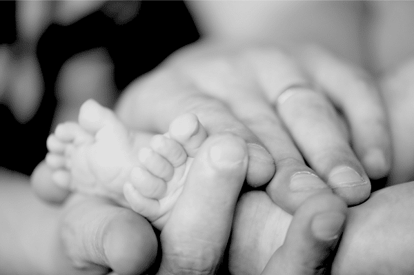 B&W Hands holding baby feet