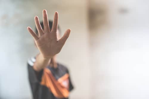 A boy in stop abusing violence hand