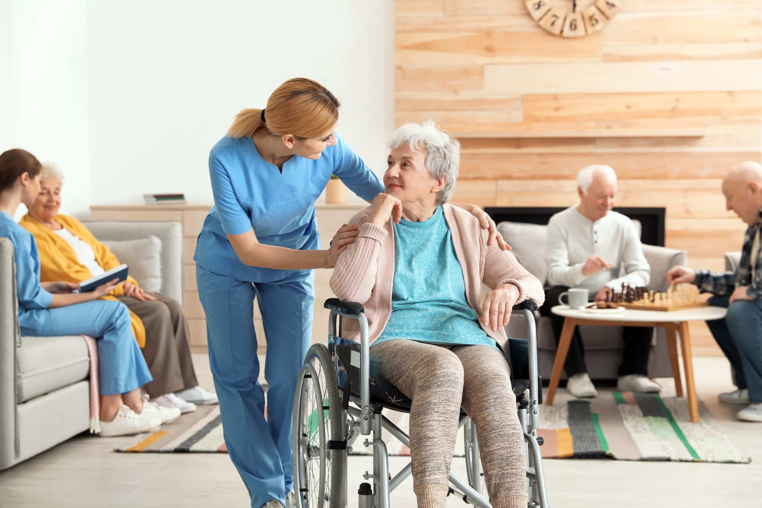 Female caretaker tends to an elderly woman in a nursing home. When abuse takes place in an elder care facility, legal action may be warranted.