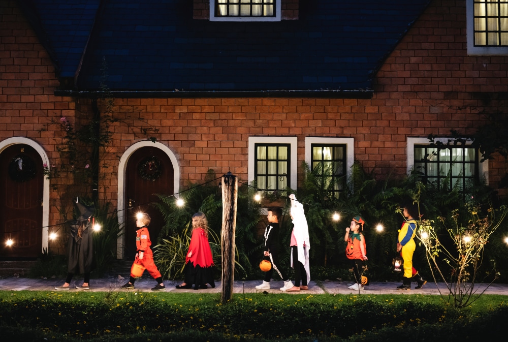 A group of children trick or treating on Halloween