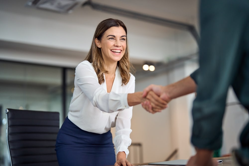 Woman shakes hands with her attorney, happy to have an emotionally supportive lawyer for her sex abuse case.